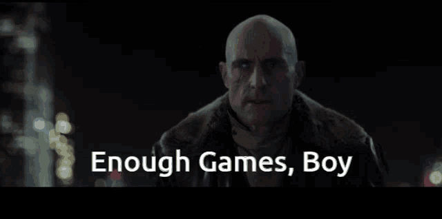 a bald man with blue eyes and the words enough games boy