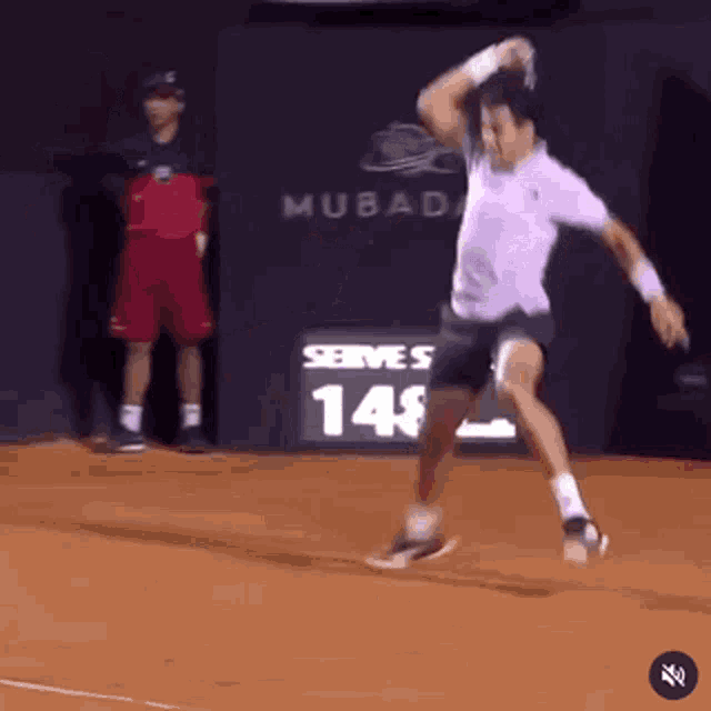 a man is playing tennis in front of a sign that says " serve 148 "