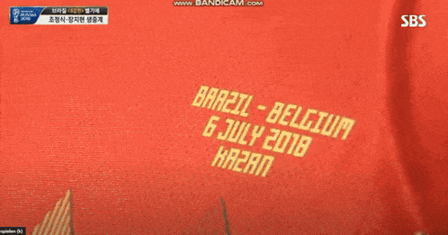 a person wearing a red shirt that says brazil belgium on it
