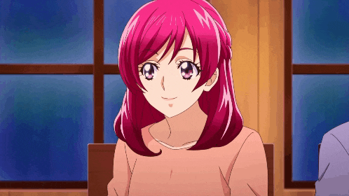 a girl with pink hair is smiling and looking at the camera