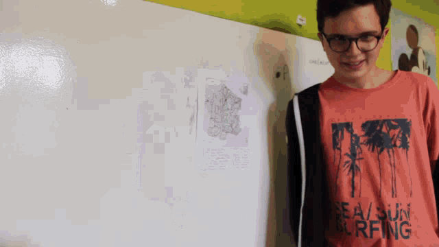 a young man wearing a sea sun surfing shirt