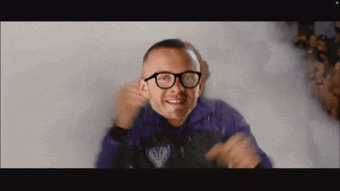 a man wearing glasses and a purple jacket with the word eagles on it