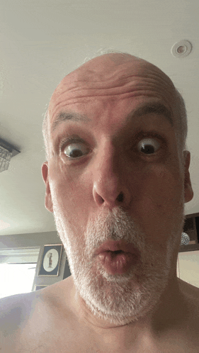 a man with a beard makes a funny face