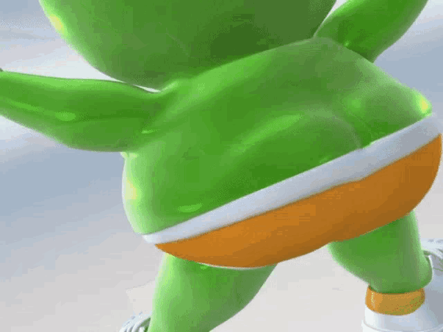 a green gummy bear is wearing a white and orange striped shorts
