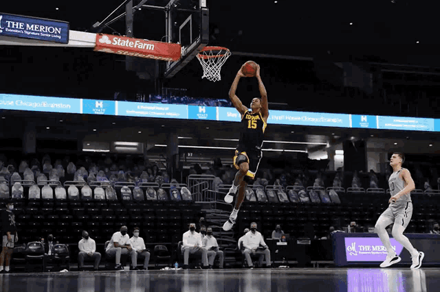 a basketball player with the number 15 on his jersey jumps in the air