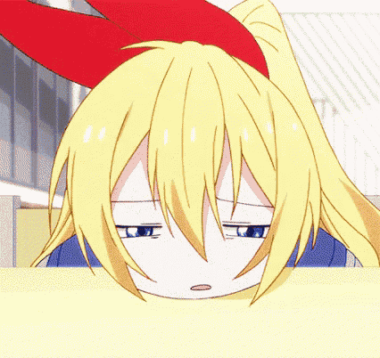 a close up of a girl 's face with a red bow on her head .