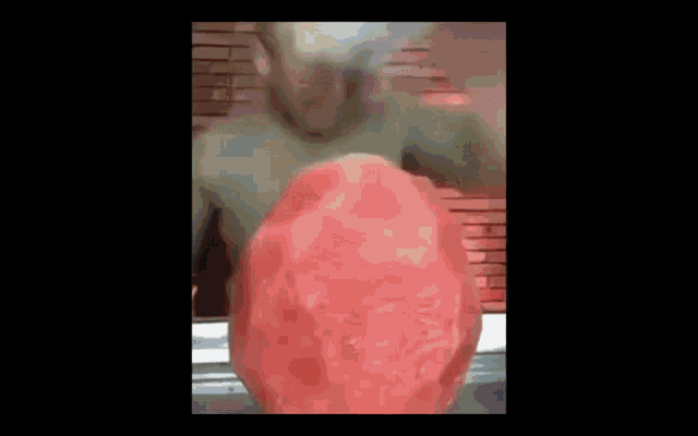 a man is eating a watermelon with his mouth open
