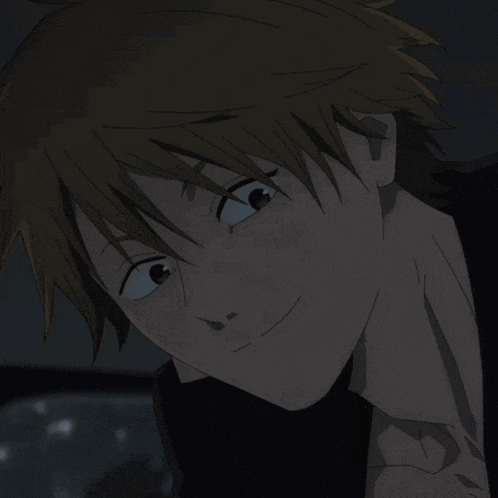 a close up of a person 's face with a slight smile on his face