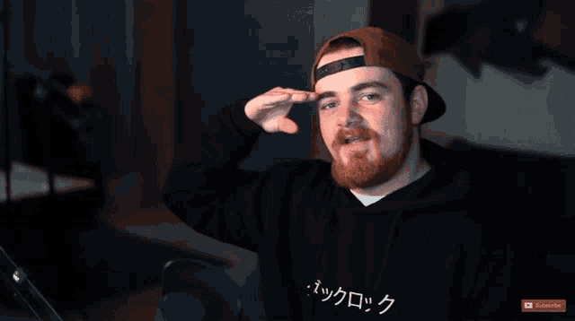 a man with a beard wears a black hoodie that says subscribe