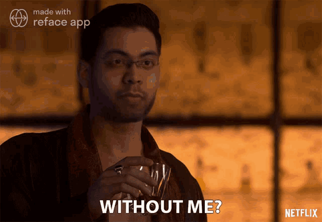 a man is holding a glass of whiskey and says without me
