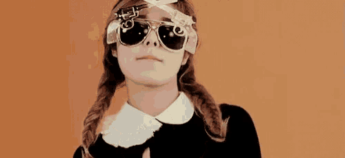a girl wearing a pair of sunglasses with a gun on it