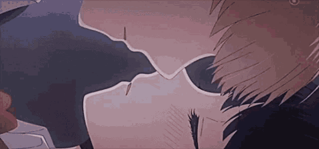 a close up of a man and woman kissing in a dark room .