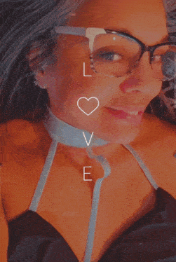 a woman wearing glasses and a choker with the word love written on it