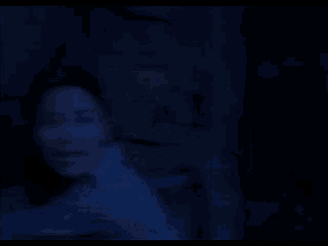 a woman in a dark room with the word ready behind her