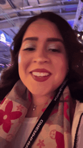 a woman wearing a lanyard that says rahmabad smiles