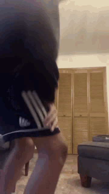 a person wearing a pair of adidas shorts is dancing