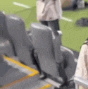 a blurry picture of people sitting in a stadium .