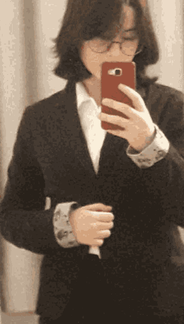 a woman taking a selfie with a red phone