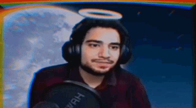 a man with headphones and a halo on his head is holding a microphone .