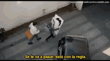 a man is carrying a large piece of paper that says " se le va a pasar esta con la regla "