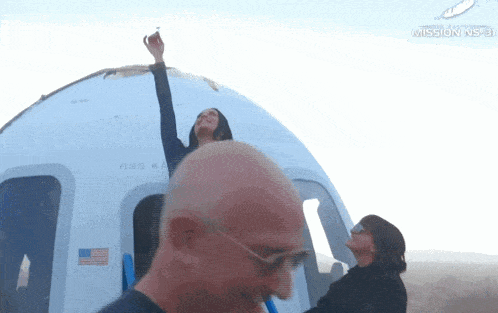 a woman stands in front of a plane with the word mission inside
