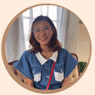 a woman wearing glasses and a blue shirt is smiling