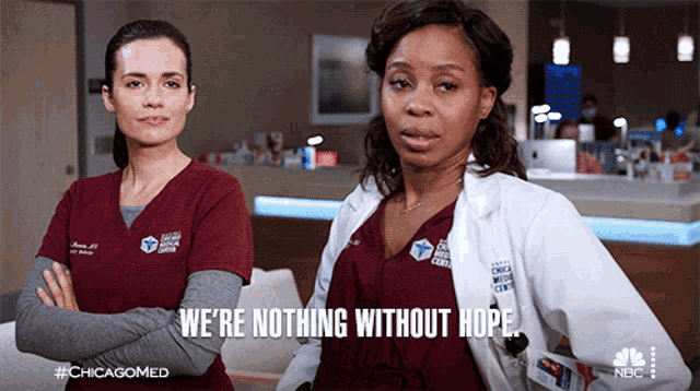 two women in scrubs are standing next to each other and one of them says we 're nothing without hope