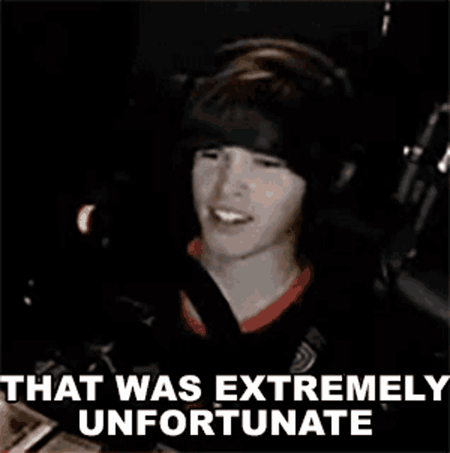 a man wearing headphones is sitting in front of a microphone with the words that was extremely unfortunate .