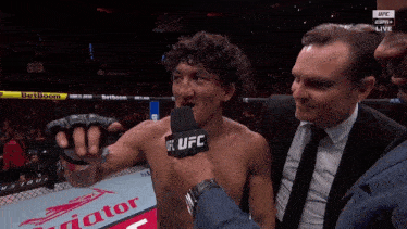 a man talking into a microphone with the word ufc on his chest