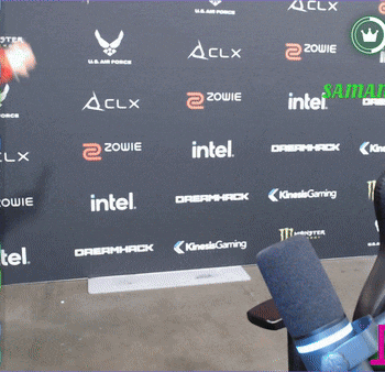 a person standing in front of a wall that has intel dreamhack and kinesis gaming written on it