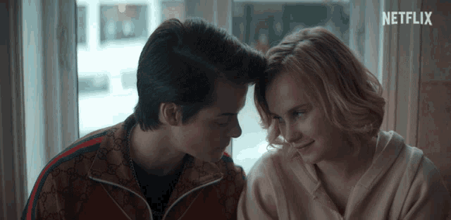 a man and a woman looking at each other with netflix written on the bottom