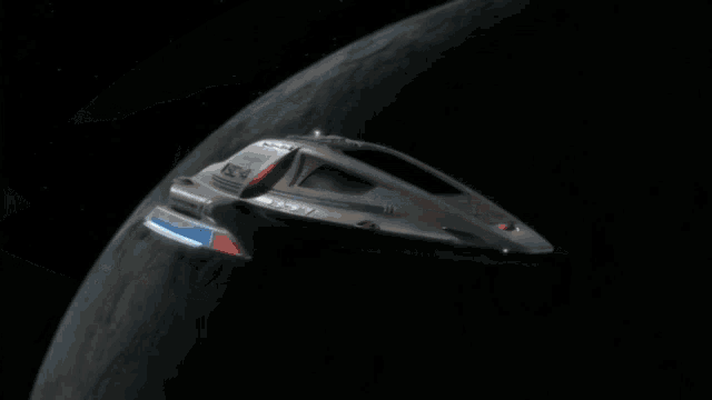 a futuristic space ship with a red light on the tail