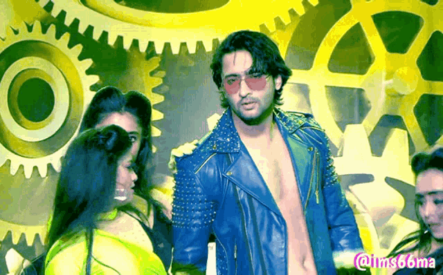 a man in a blue leather jacket stands in front of a group of people