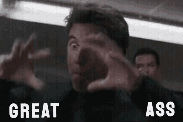 a man is making a face with his hands and the words great ass are behind him