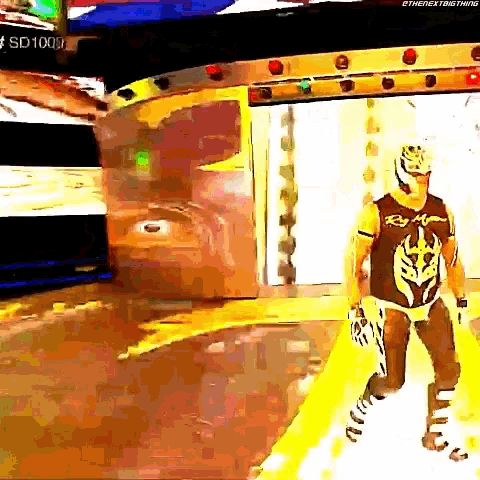 a man in a wrestling outfit is walking in a room with a sign that says sd 1000 on it .