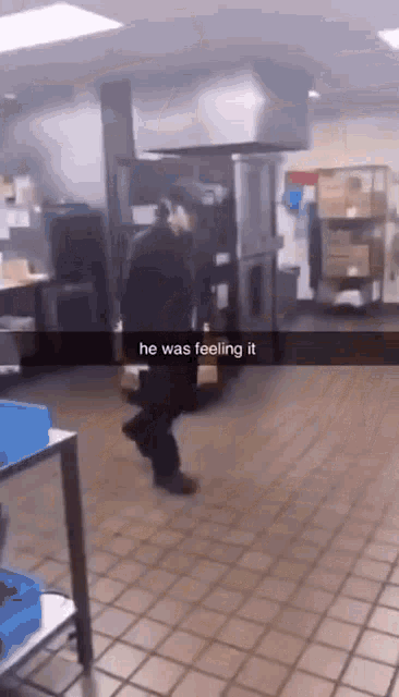a man is walking in a kitchen with the words he was feeling it on the bottom