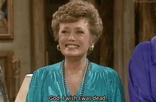 a woman in a blue dress is smiling and saying `` god , i wish i was dead . ''