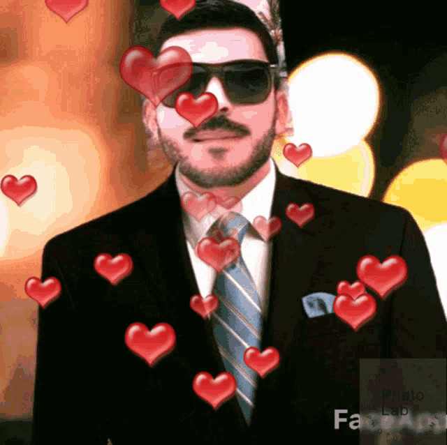 a man in a suit and tie is surrounded by red hearts and says photo lab