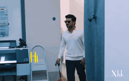 a man walking a dog in a hallway with xhk written on the bottom left