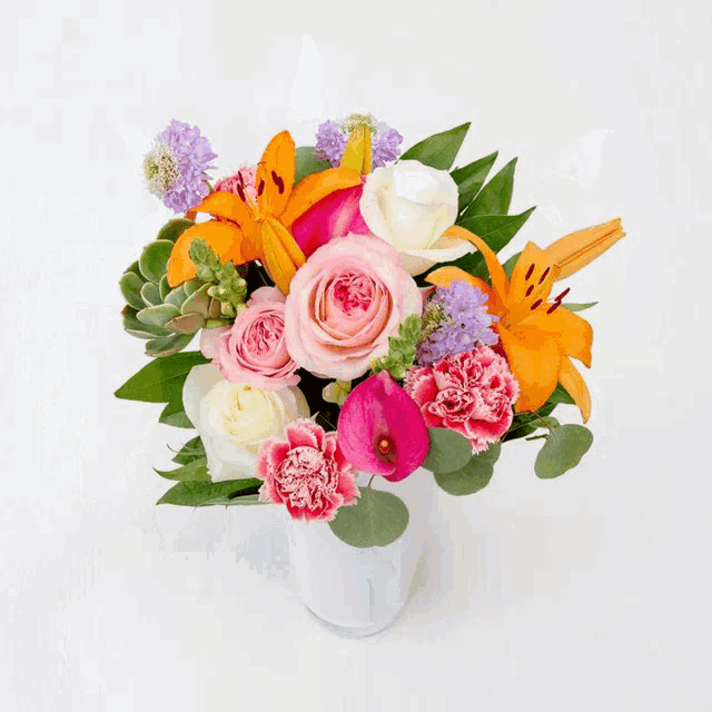 a bouquet of flowers with pink roses and yellow flowers