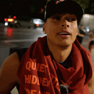 a man wears a scarf that says quiet hidden
