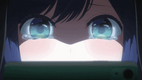 a close up of a girl 's eyes with tears running down her face