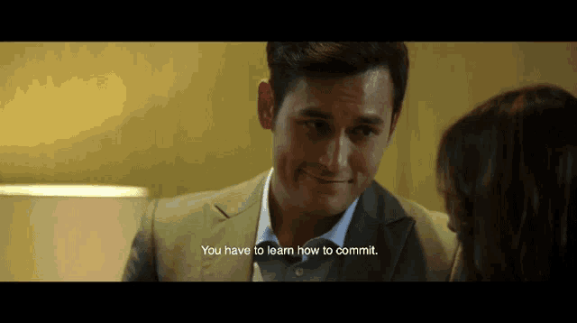 a man in a suit says " you have to learn how to commit " to a woman