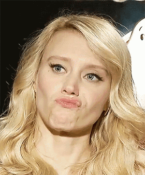 a close up of a blonde woman making a face