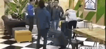 a group of people are standing around a checkered floor .