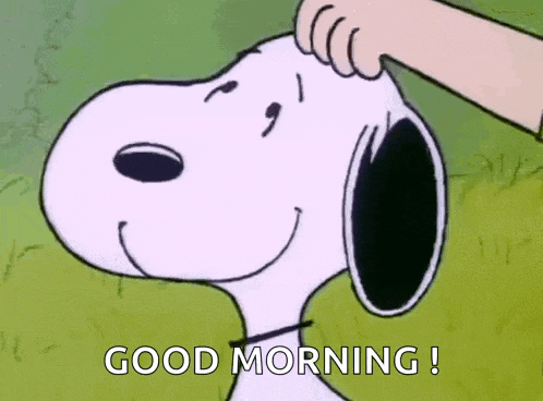 snoopy is smiling and being patted on the head by a hand .