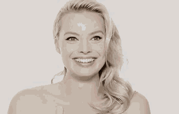 a naked woman with long blonde hair is smiling and looking at the camera .