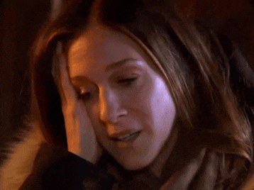 a woman is talking on a cell phone with her eyes closed