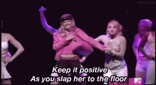 a group of women are dancing on a stage and one of them says `` keep it positive as you slap her to the floor ''