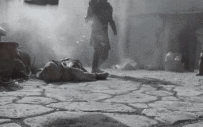 a black and white photo of a man laying on the ground with smoke coming out of him